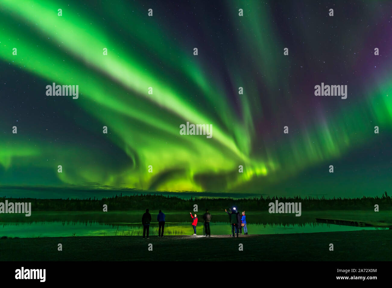 A group of aurora tourists take their aurora selfies at Prosperous Lake, near Yellowknife, NWT, a popular spot on the Ingraham Trail for aurora watchi Stock Photo