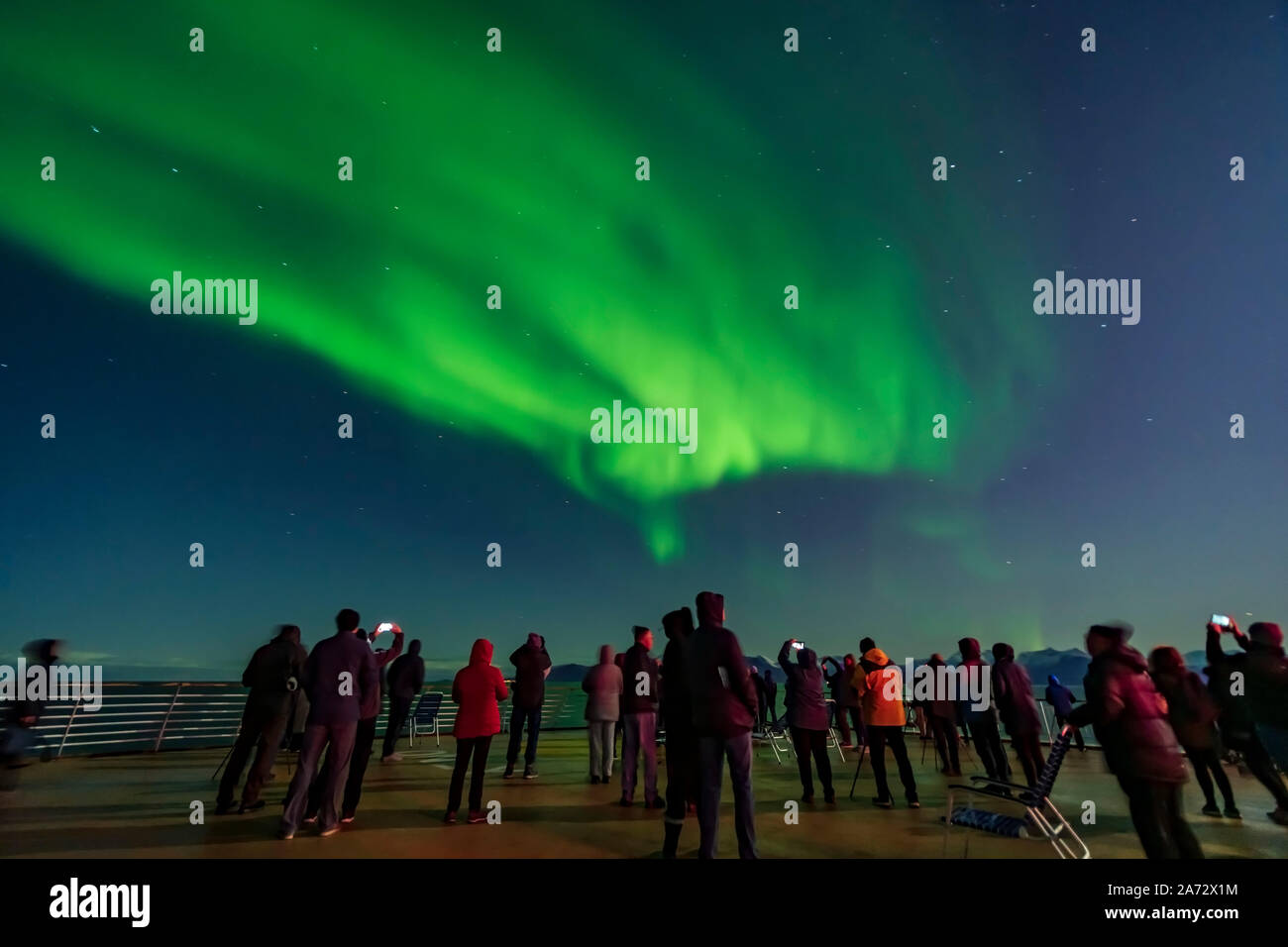 The Northern Lights from the deck of the ms Trollfjord, a ferry in the Hurtigruten fleet. This was out of Tromsø sailing north toward Skjervøy. As is Stock Photo