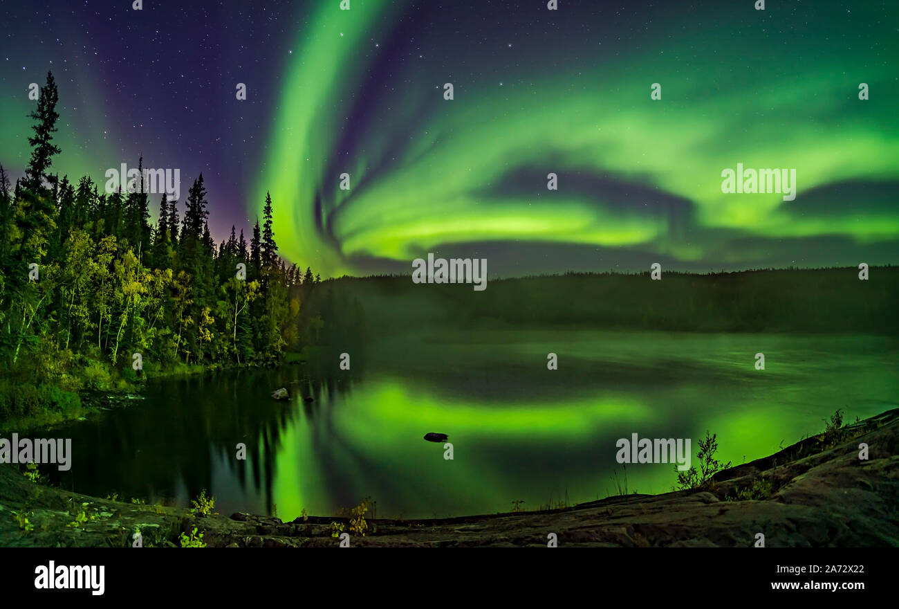 The Northern Lights in an arc across the northern sky over the Cameron River, downriver from the Ramparts Falls. This was September 8, 2019 with the t Stock Photo