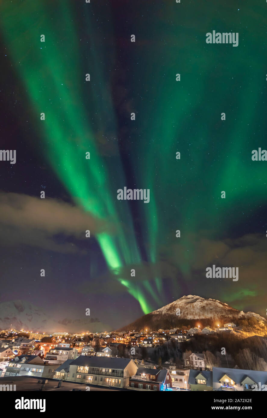 The Northern Lights over the village of Skjervøy on the northern coast of Norway north of Tromsø. Taken from the deck of the Hurtigruten ship the ms T Stock Photo