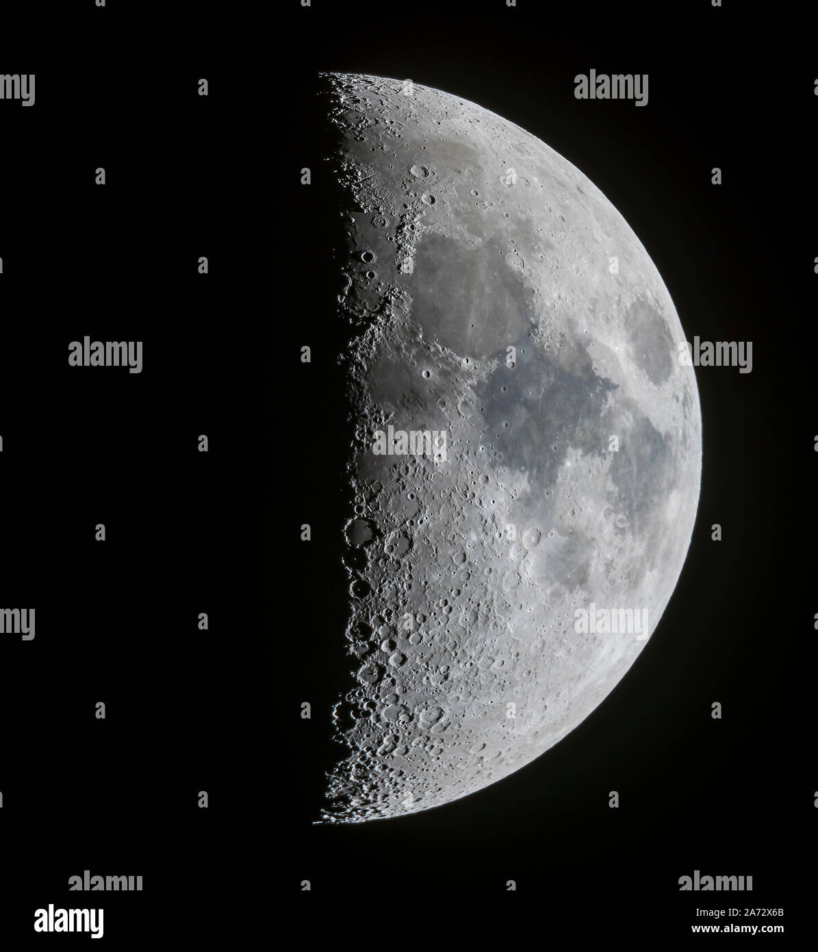 A panorama of the 7-day-old first quarter Moon on March 13, 2019, showing the full disk and extent of incredible detail along the terminator, the divi Stock Photo