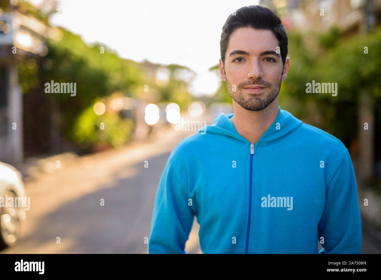 Face of young handsome man with stubble beard outdoors Stock Photo