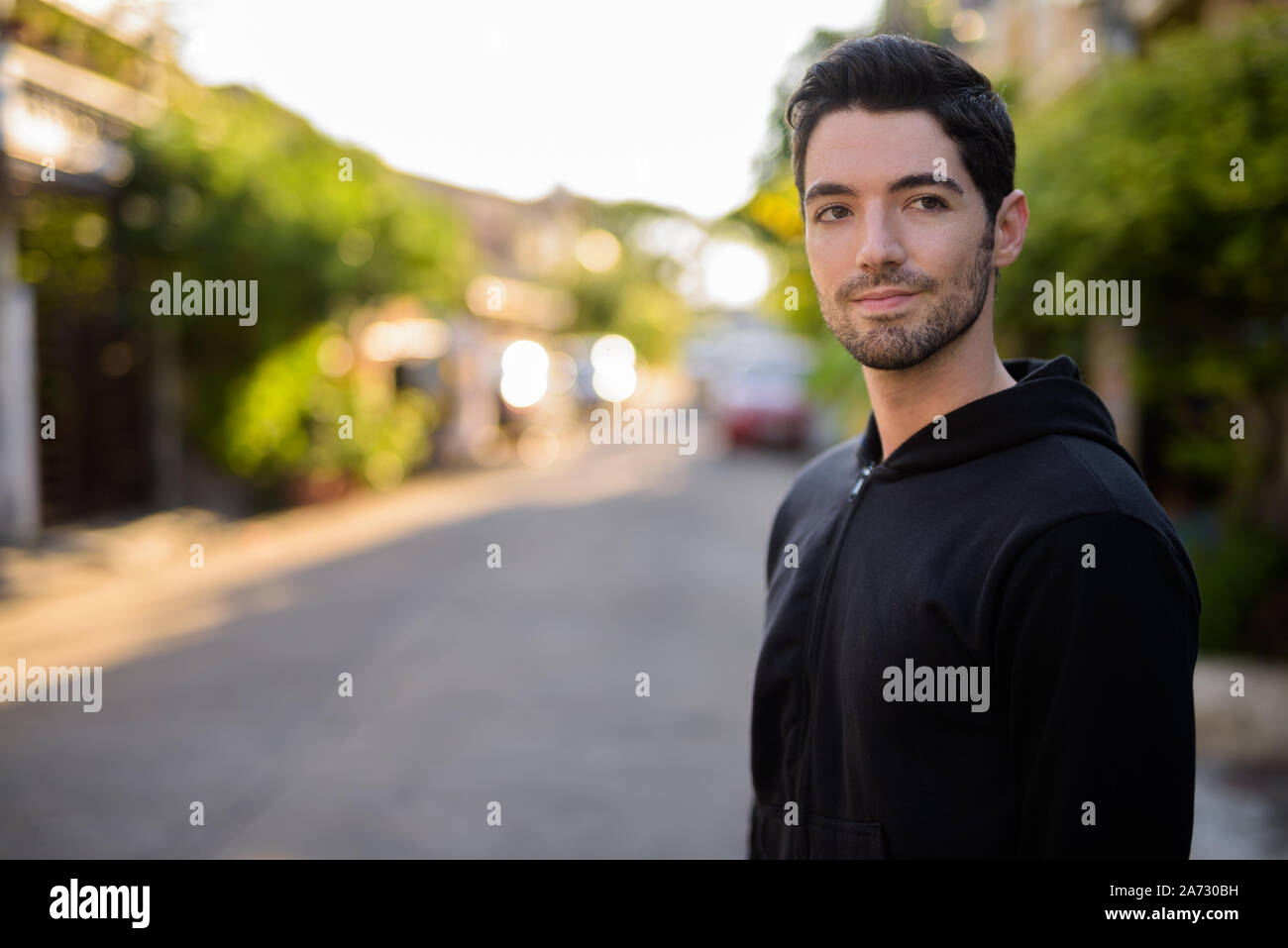 Young handsome man with stubble beard outdoors Stock Photo