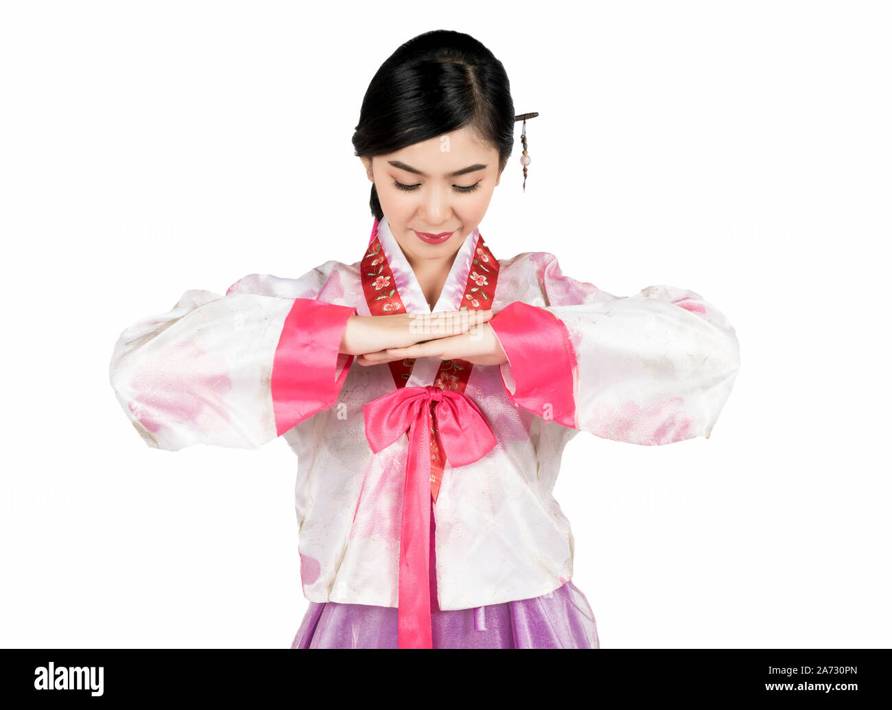 Portrait of young attractive Korean Woman with Hanbok, the traditional Korean dress smiling with white background with clipping path feeling confident Stock Photo