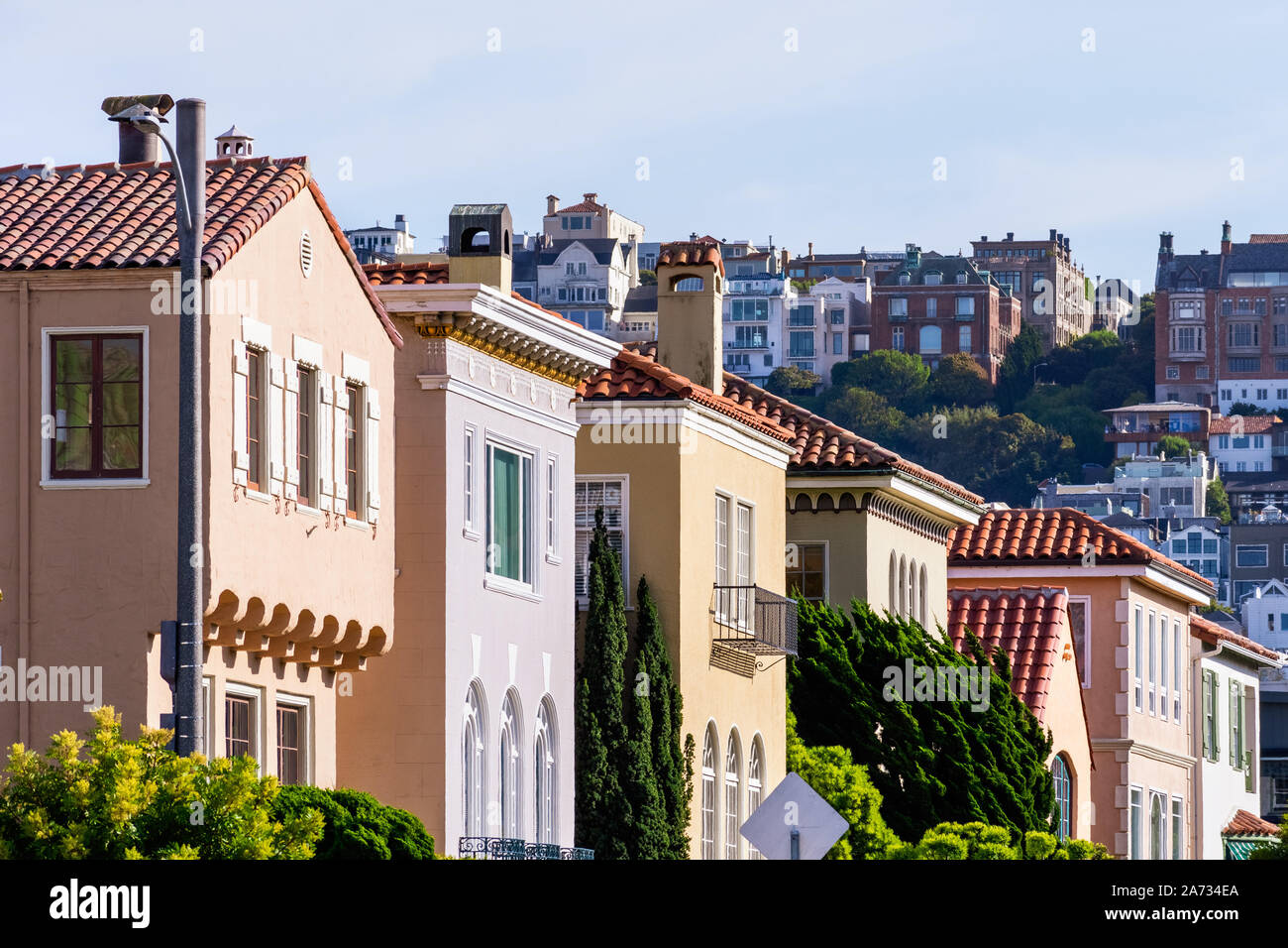 Row of colorful houses in the Marina District residential neighborhood; Pacific Heights residential district visible in the background; San Francisco, Stock Photo
