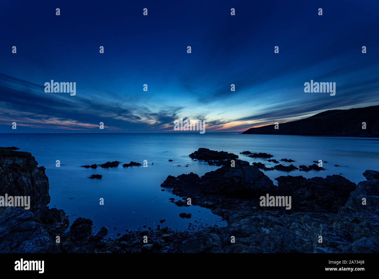Church Bay at dusk on a high tide, Anglesey, North Wales Stock Photo