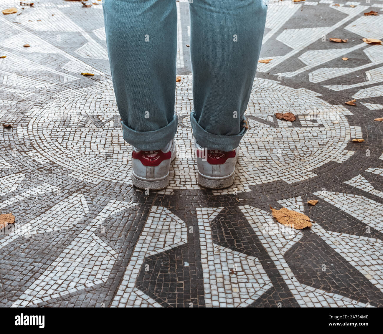 NEW YORK CITY, USA - 2017 SEPTEMBER 7, Woman legs over The caption 'Imagine' on the 'The Beatles' memorial mosaic, in Strawberry Fields (Central Park) Stock Photo