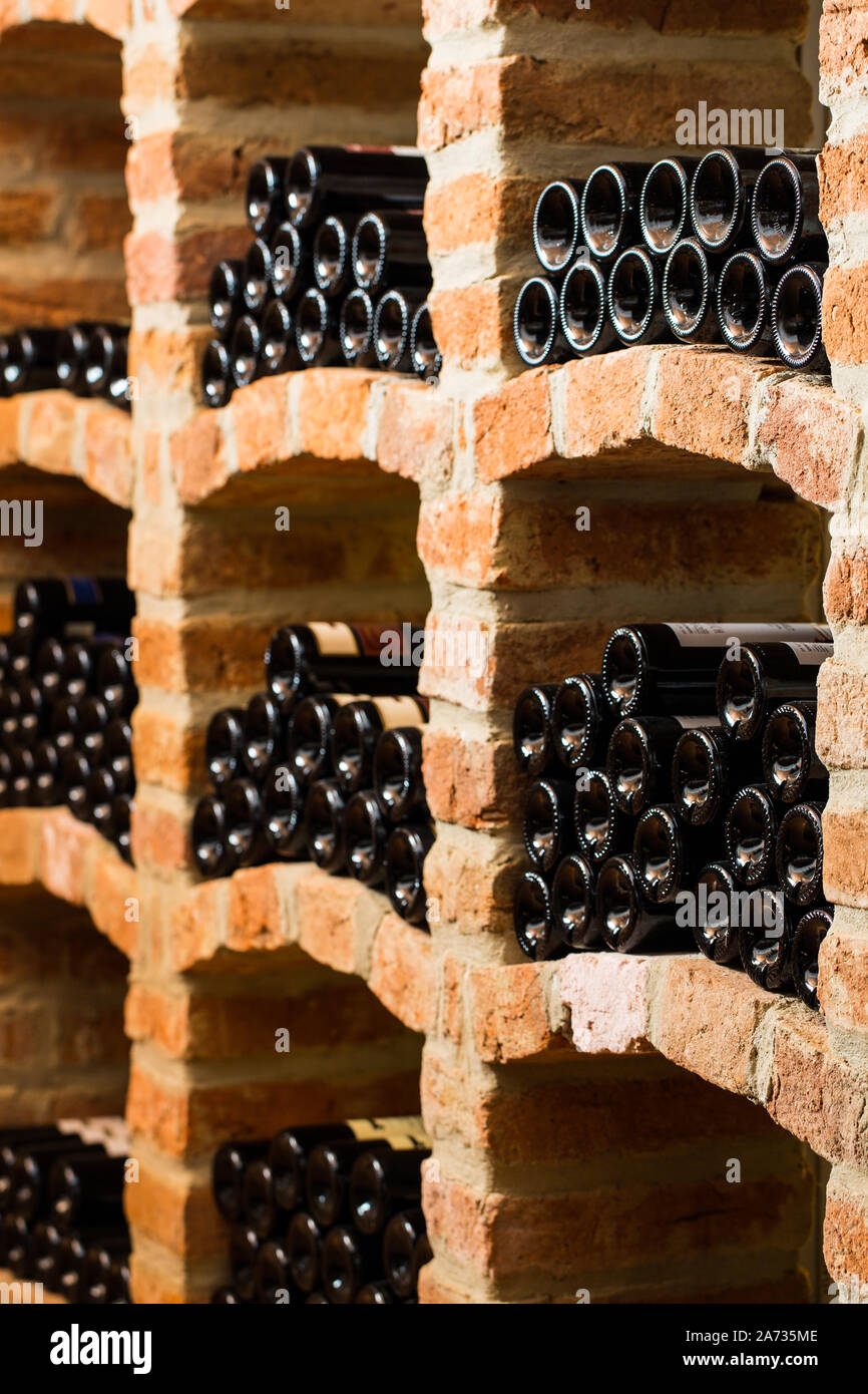 Many bottles in the vaulted cellar Stock Photo