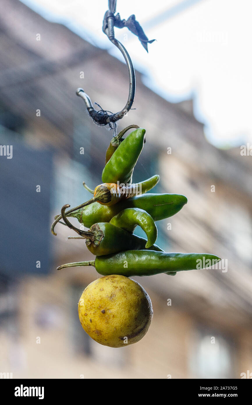 Nazar battu - traditional Nepalese amulet, made of chilly peppers and lime hanging in front of a house, protection against evil eye. Kathmandu, Nepal Stock Photo