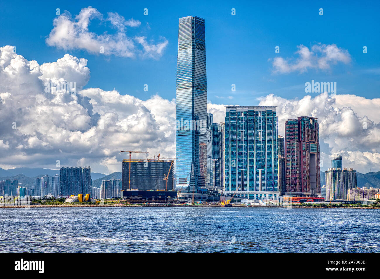 Hong Kong Victoria Harbour International Commerce Centre cityscape and gathering storm clouds. Stock Photo