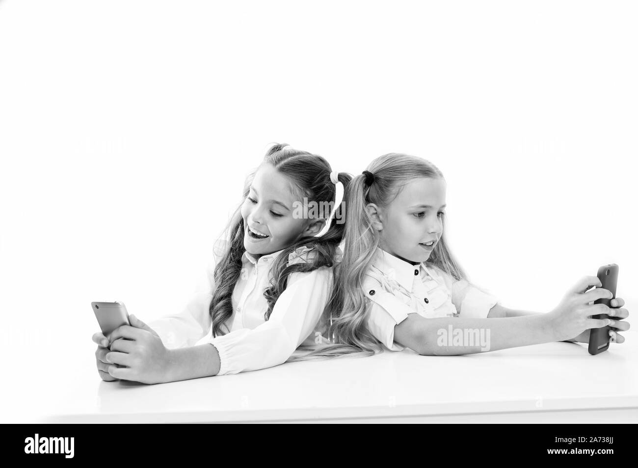 Bring the power of mobile learning into the classroom. Small children having lesson on mobile