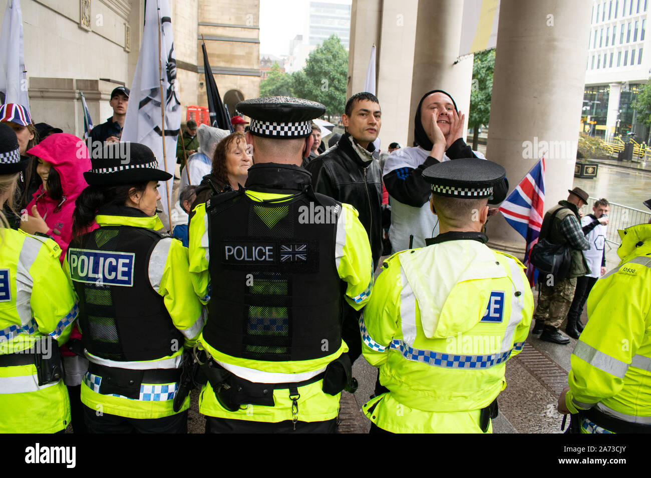 Pro Brexit protester at Conservative Party conference behind police line on steps in front of Manchester Central Library UK Stock Photo