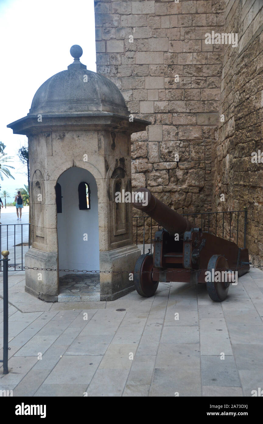 Bronze Canon on Wooden Wheels and Stone Sentry Guard Box Outside the Royal Palace of La Almudaina in Palma, Mallorca, Balearic Islands, Spain, EU. Stock Photo