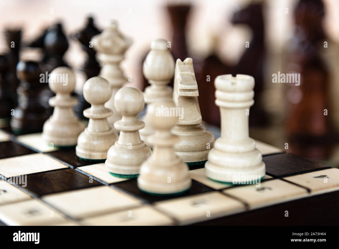 Close up of chessboard with classic wooden pieces with selective focus Stock Photo