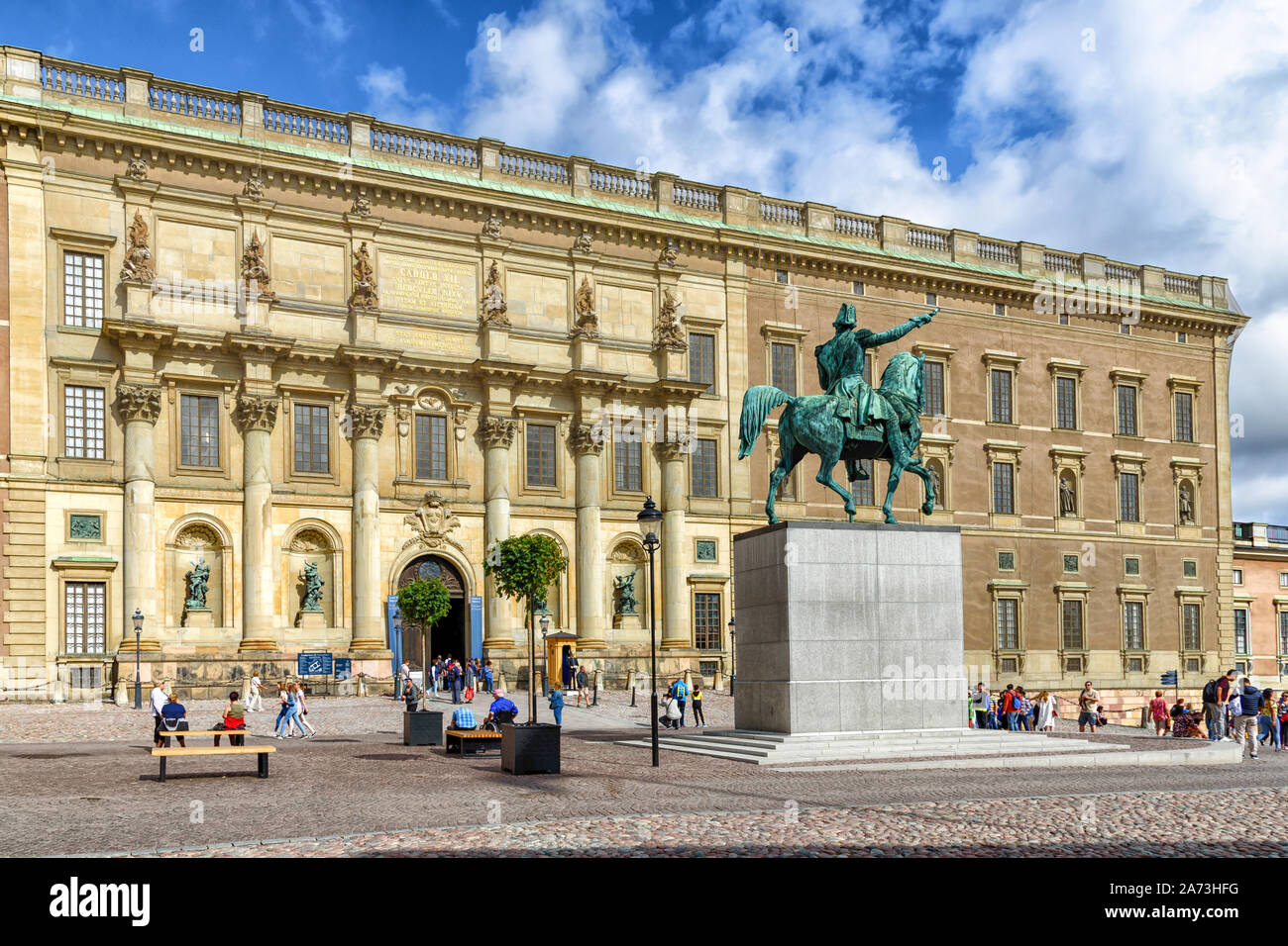 Stockholm, Sweden - August 09, 2019: Tourist visiting Royal Palace and the equestrian statue of the Swedish king Karl XIV sculpted by Johan Bengt Foge Stock Photo