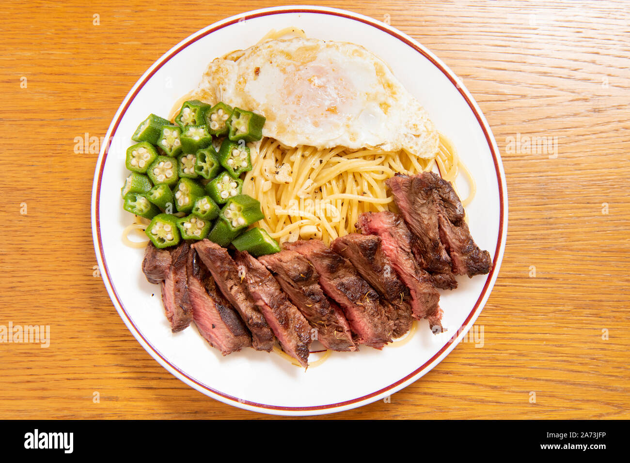 Steak Italian pasta (garlic, poached egg, okra, steak, spaghetti Stock