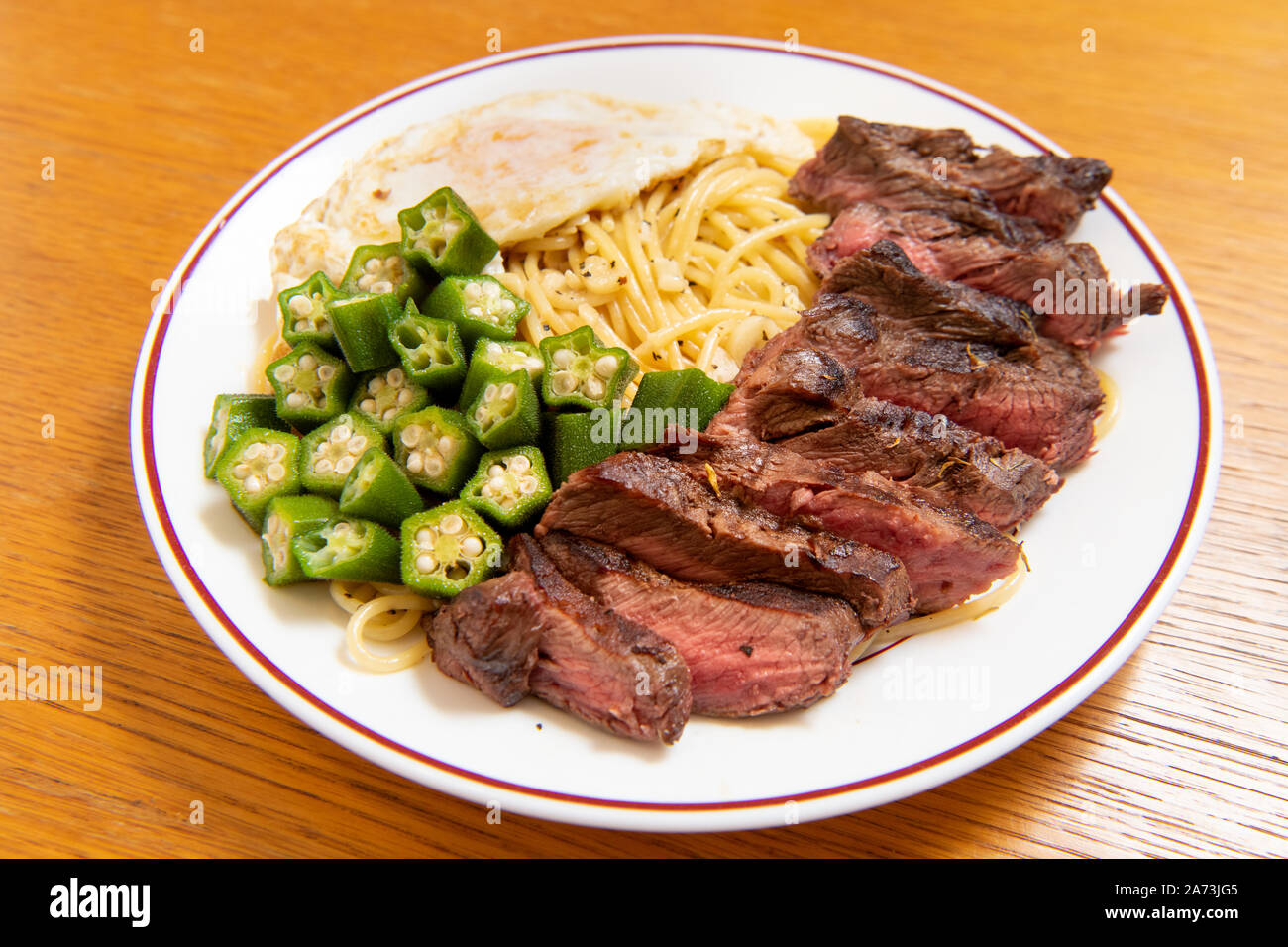 Steak Italian pasta (garlic, poached egg, okra, steak, spaghetti Stock