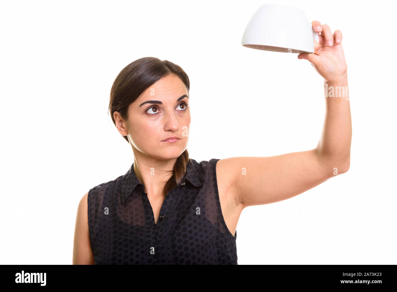 Beautiful woman holding empty coffee cup upside down Stock Photo Alamy