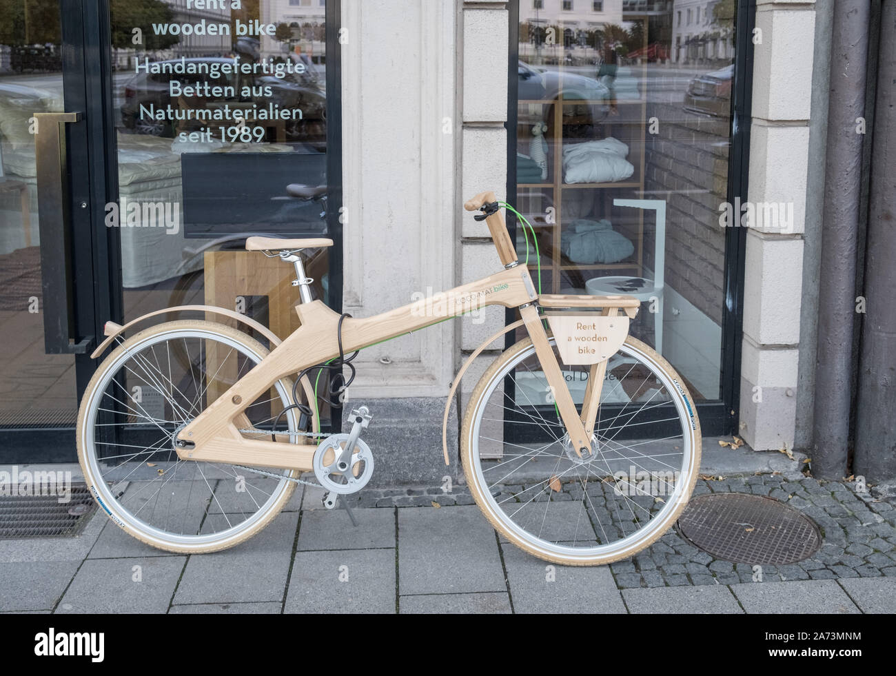 Munich, Bavaria, Germany. A bicycle made from wood available for rental hire displayed on a Munich street. Stock Photo