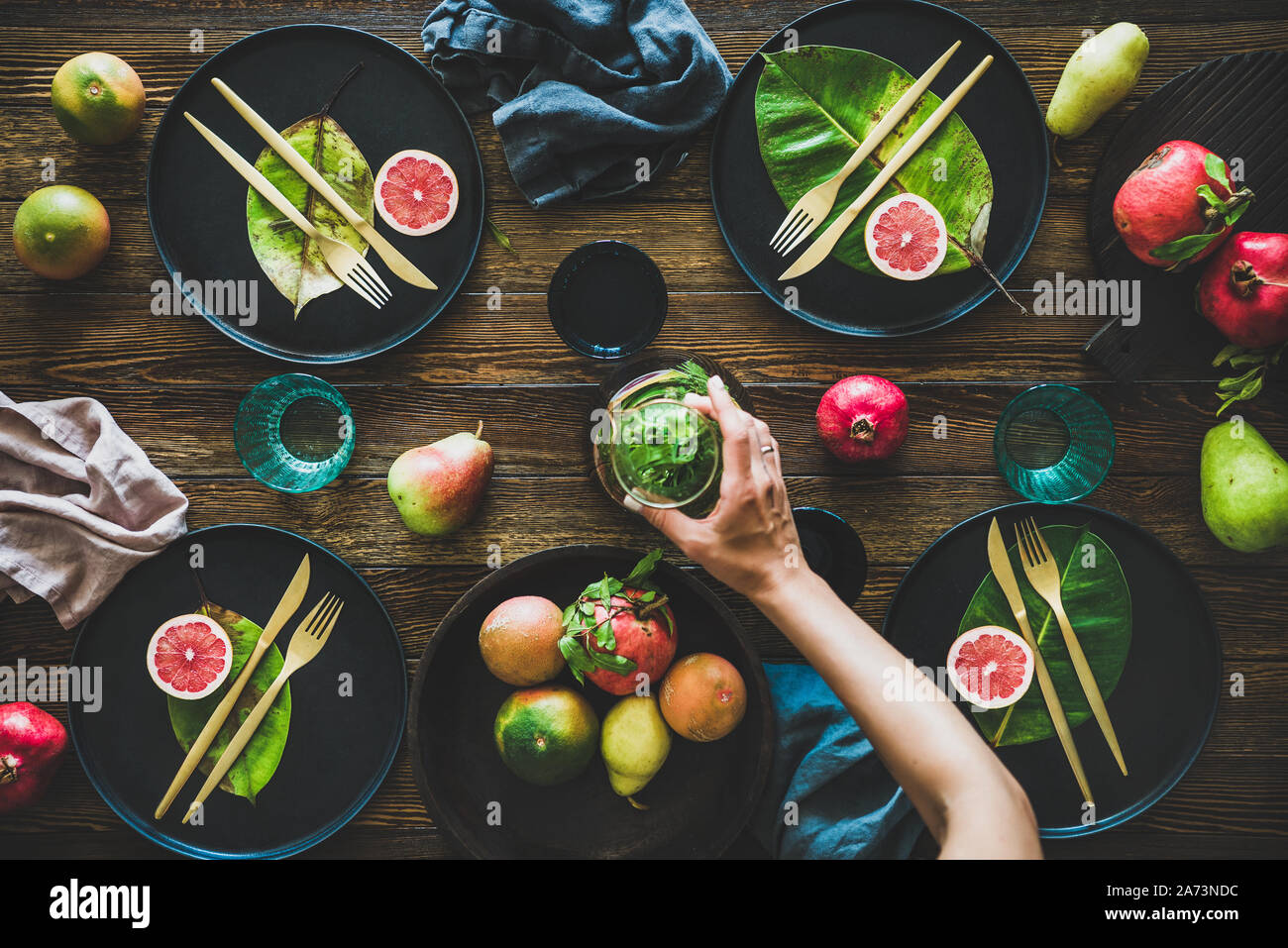 Autumn table styling for holiday and female hands holding jug Stock Photo