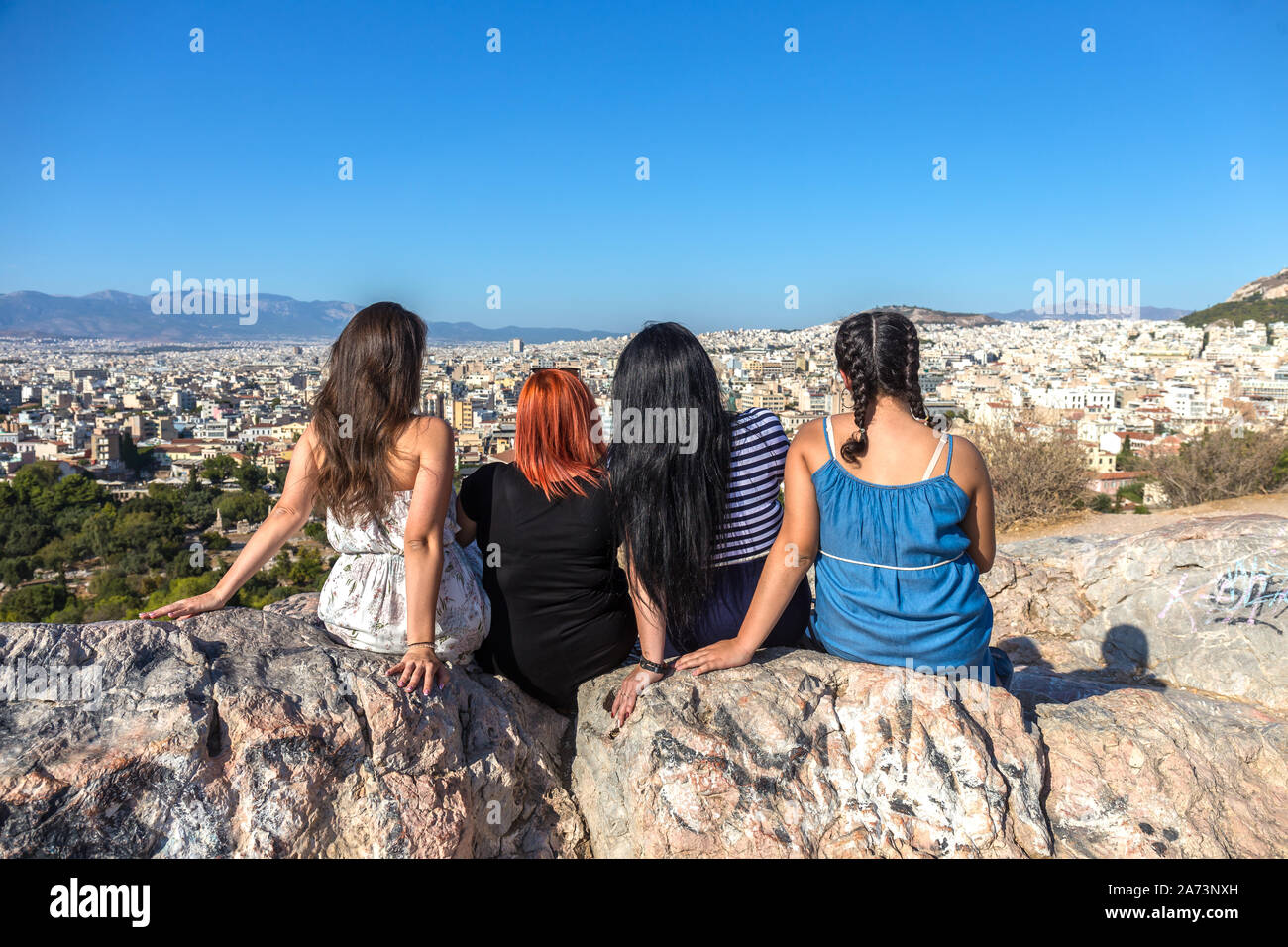 women enjoying the fantastic view from the outlook mountain Areopagus overseeing Athens city Stock Photo