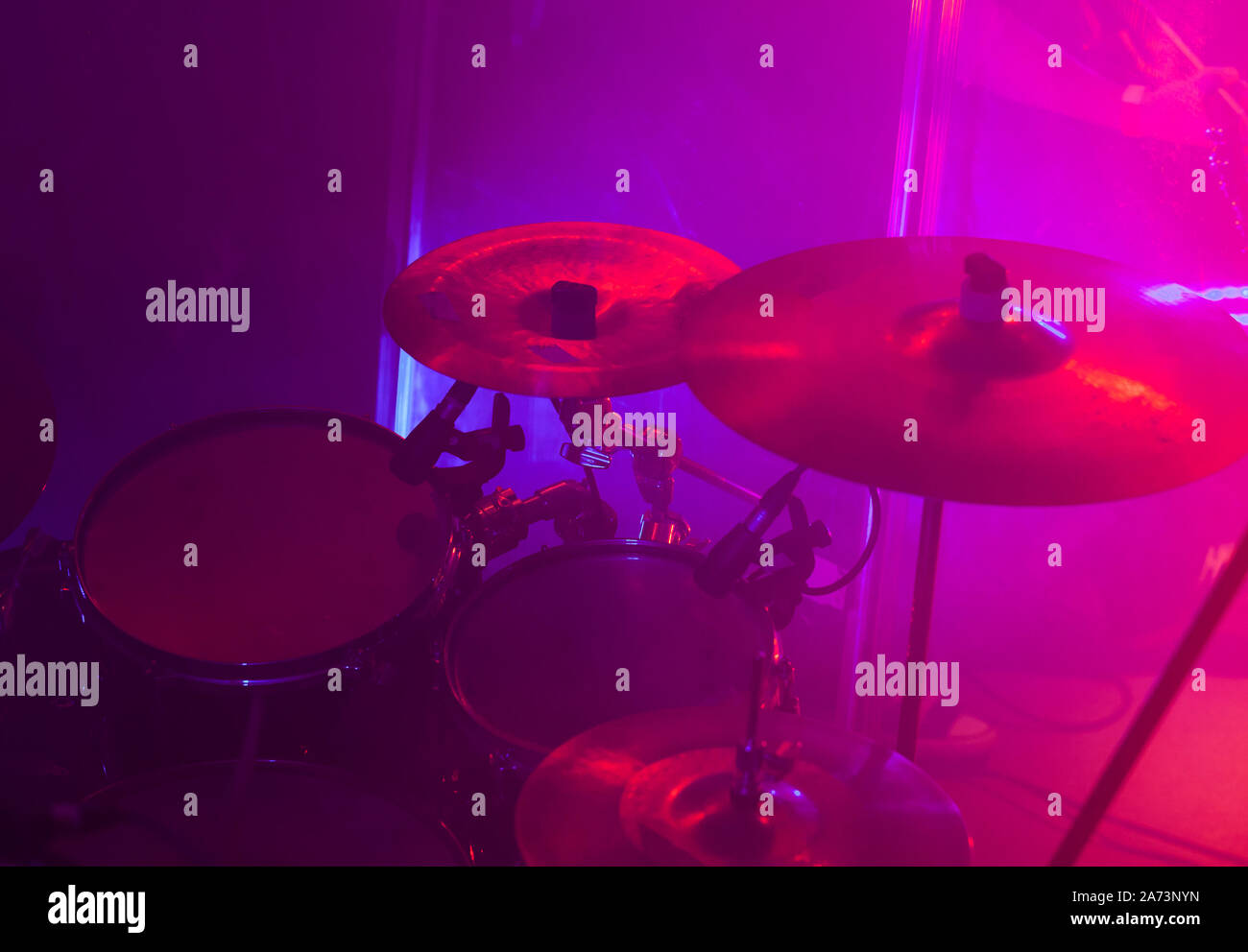 Rock band drum set in purple stage lights, close-up photo, soft selective focus Stock Photo