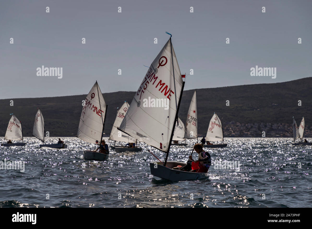 Montenegro, Sep 20, 2019: The Optimist Class dinghy sailing regatta in Kotor Bay Stock Photo