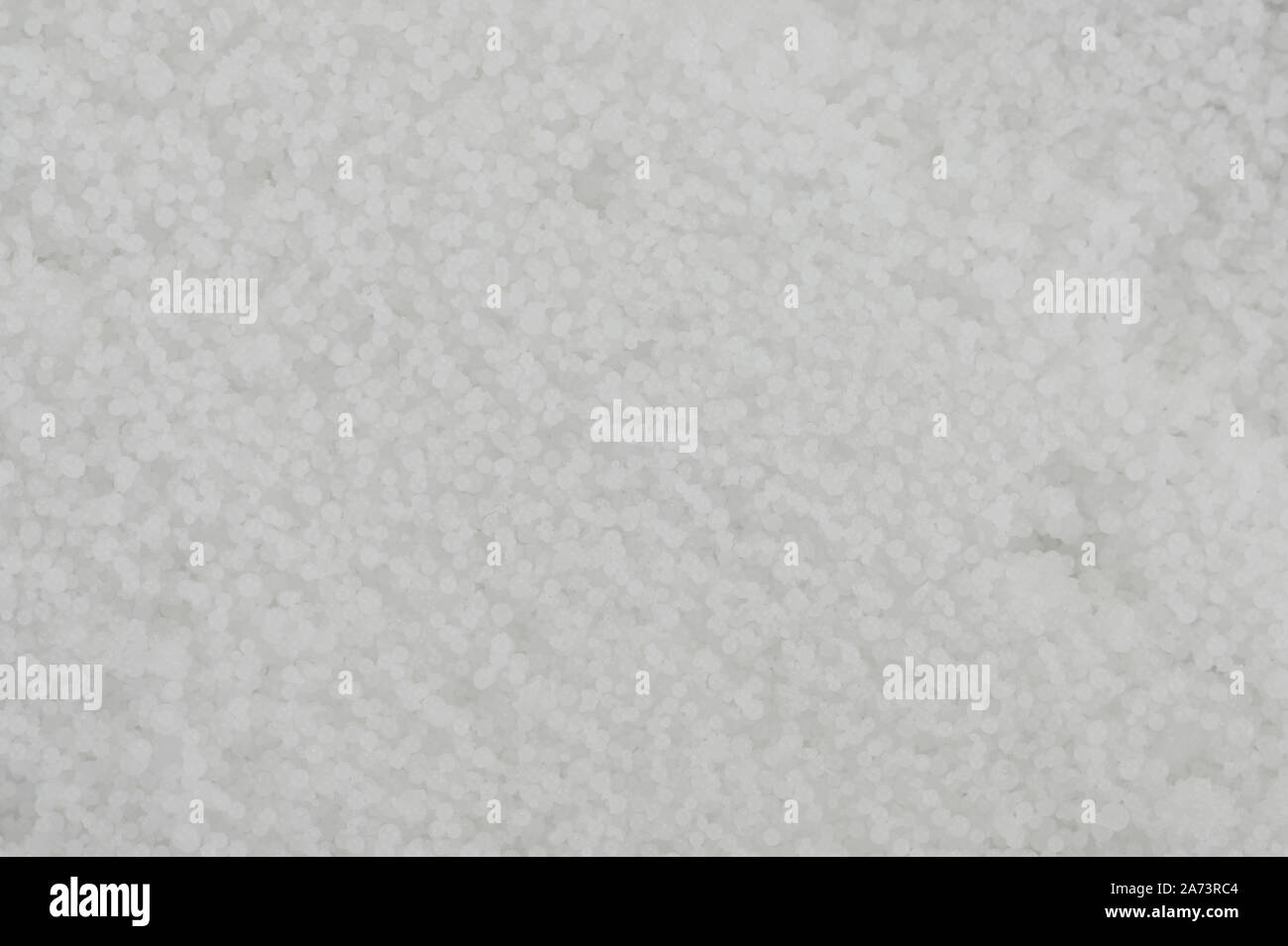 White granular background close up view. Wax small balls Stock Photo