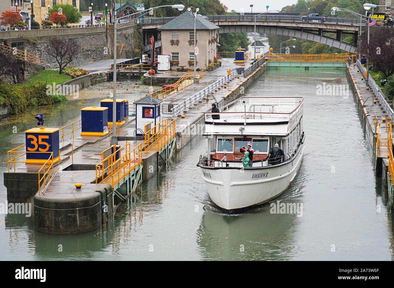 Erie Canal cruise boat Lockview V, a 125-passenger double-deck motor vessel built of the Great Lakes, exiting lock 34 at Lockport, New York. Stock Photo