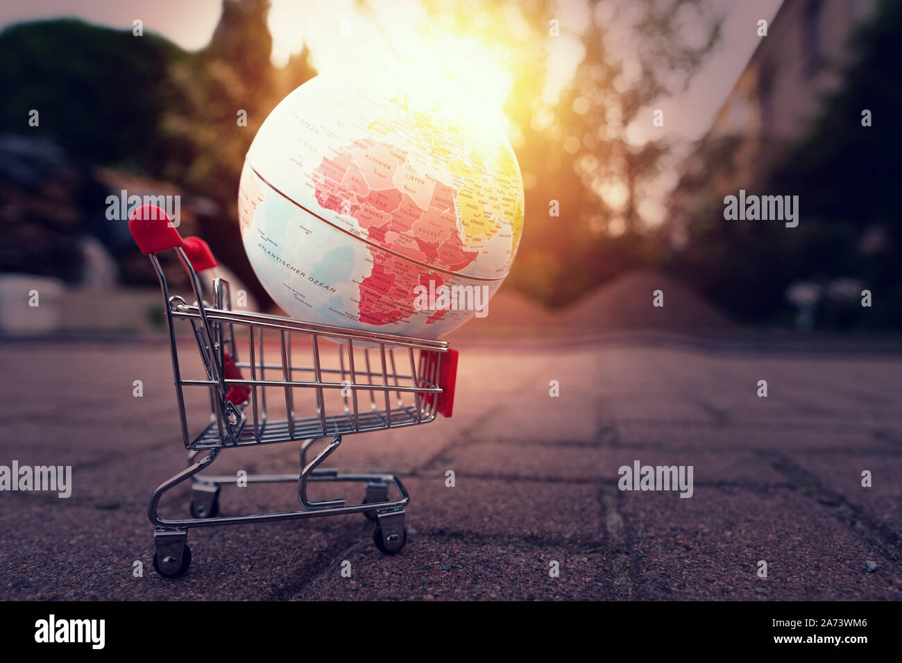 Planet earth in a shopping cart with sun Stock Photo