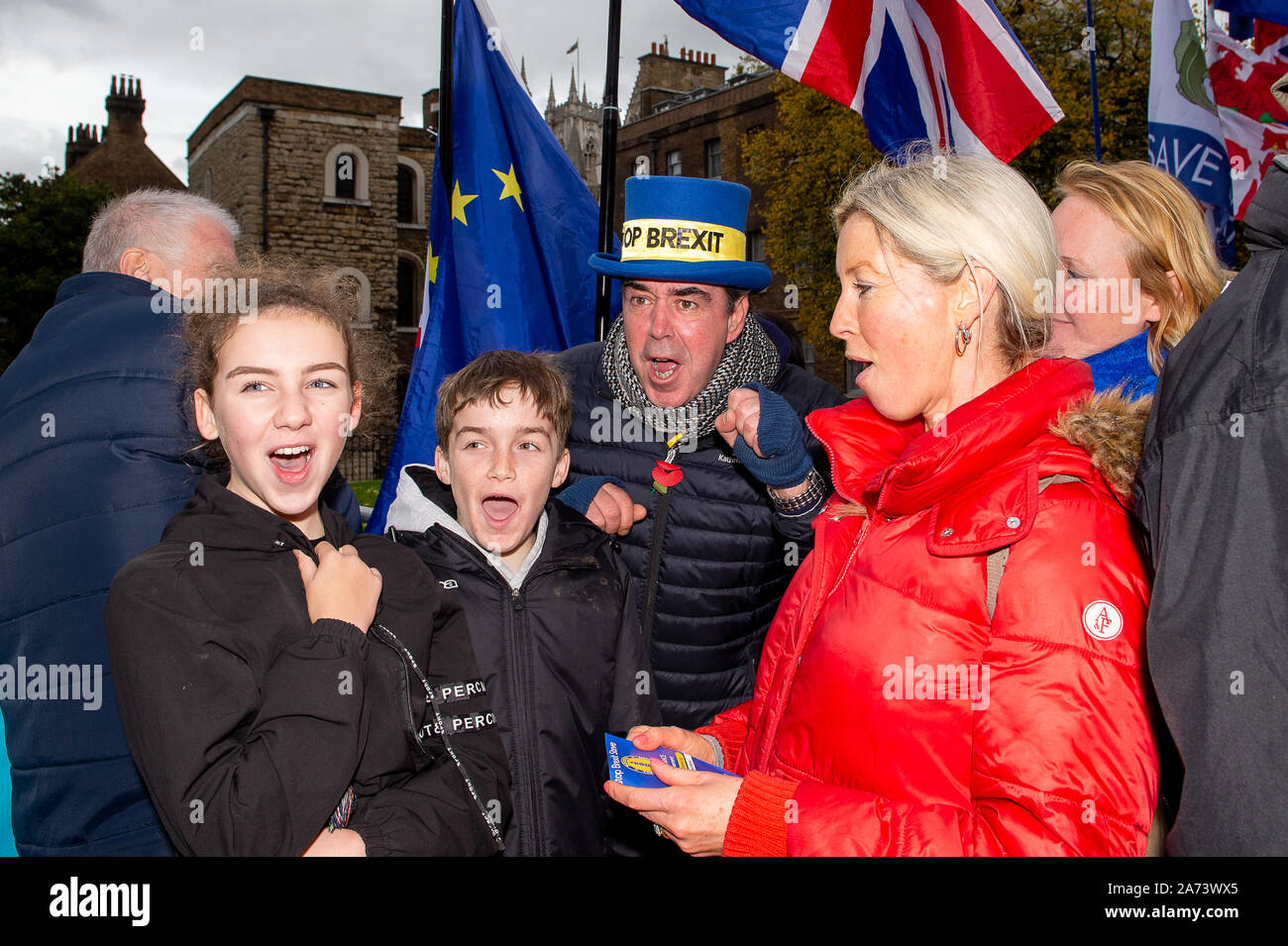 Westminster, London, UK. 29th October, 2019. SODEM Stop Brexit man Steve Bray poses for a photo with a family as they shout Stop Brexit at College Green, Westminister. Credit: Maureen McLean/Alamy Stock Photo