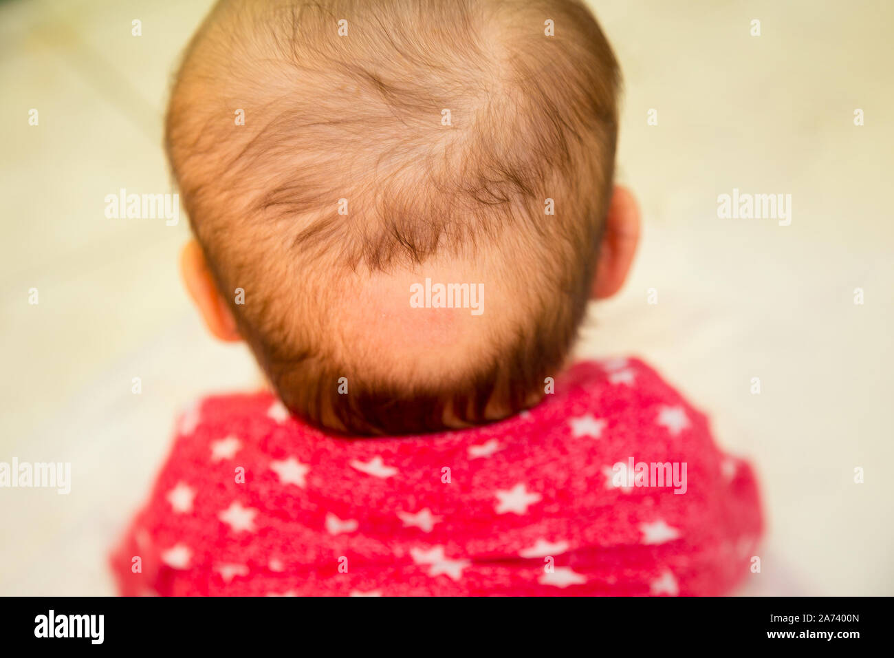 Bald spot on the back of the head of a small baby Stock Photo