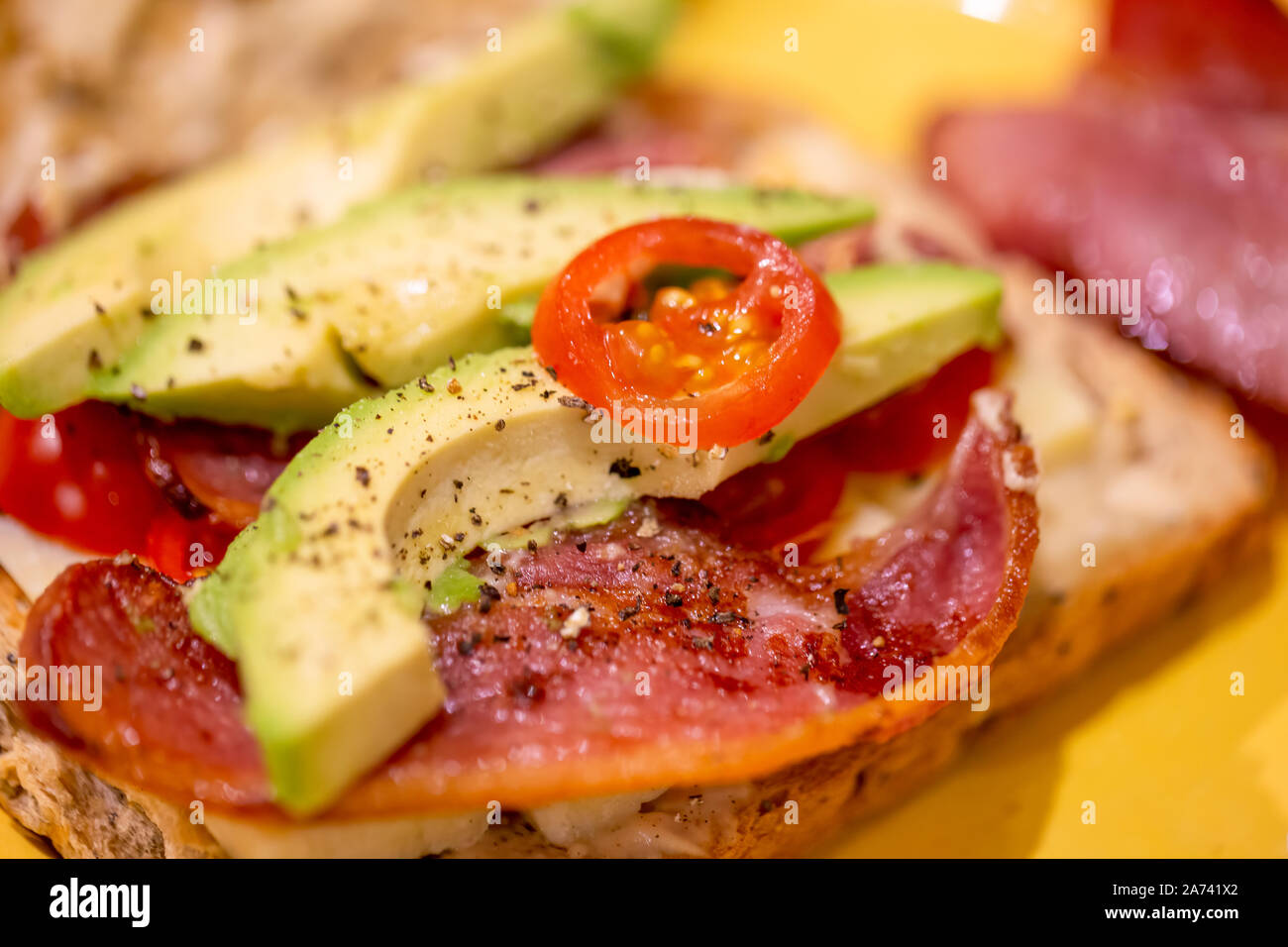 Bacon, avocado, cheese and tomato open sandwich Stock Photo Alamy
