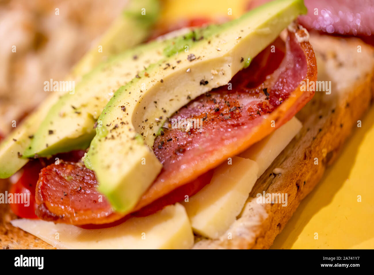 Bacon, avocado, cheese and tomato open sandwich Stock Photo Alamy