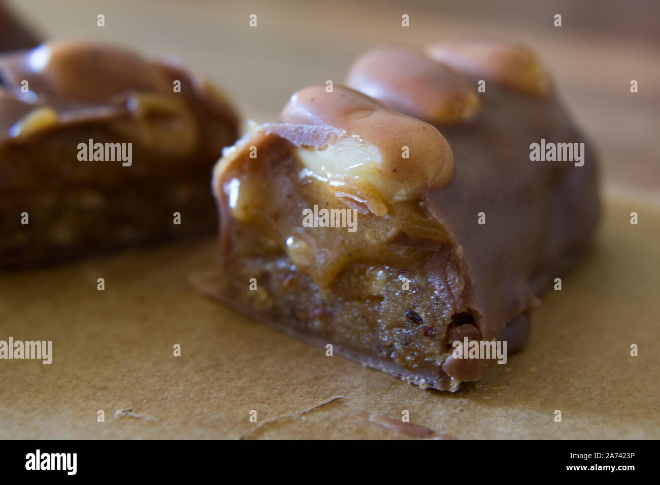 Food photography of a raw food chocolate bar with peanuts and caramel Stock Photo