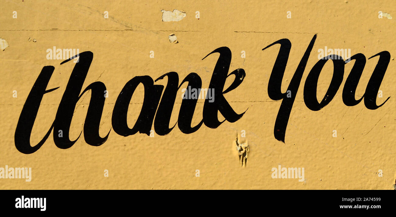 thank you painted on a yellow sign Stock Photo