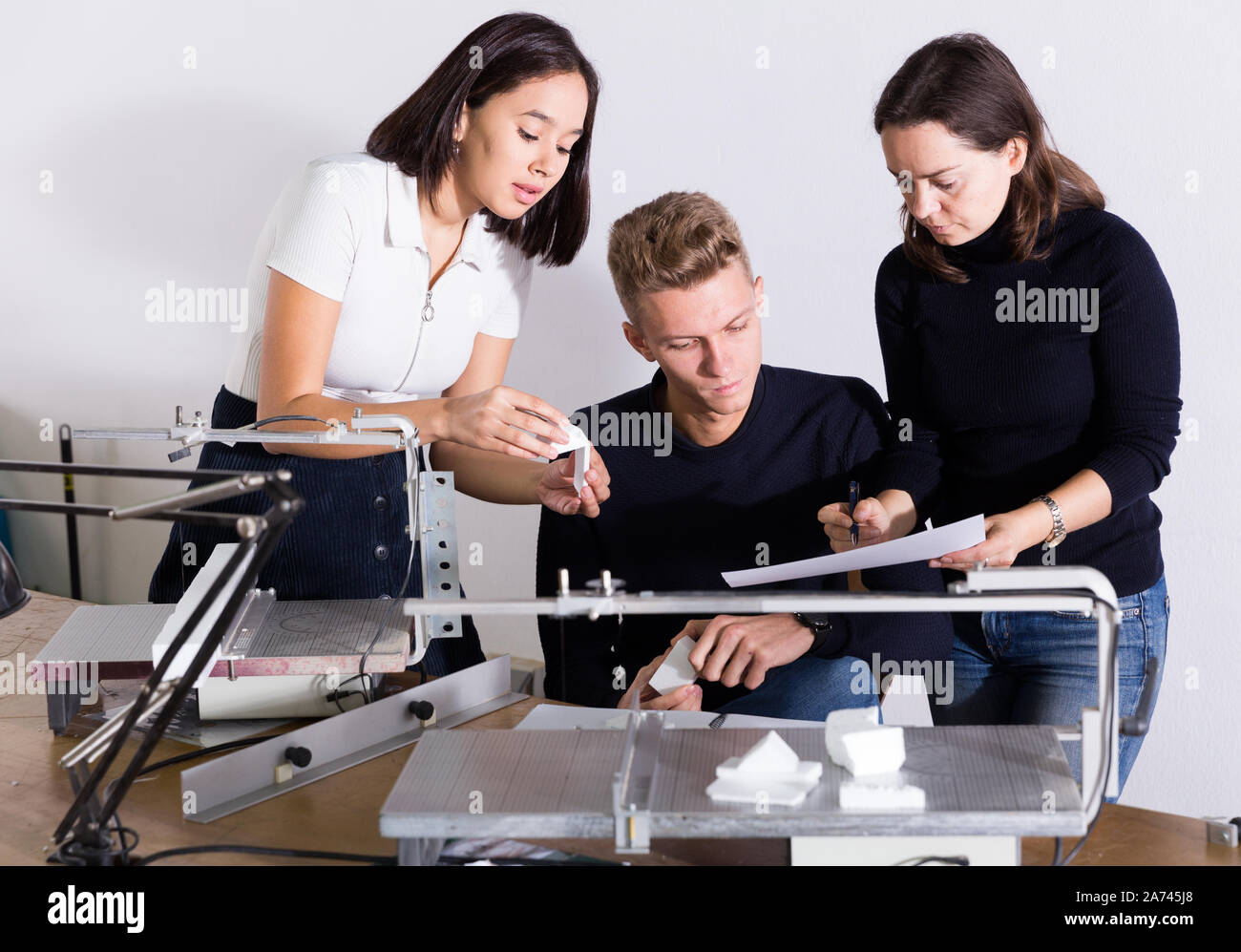 Group of architects working in design and engineering office ...