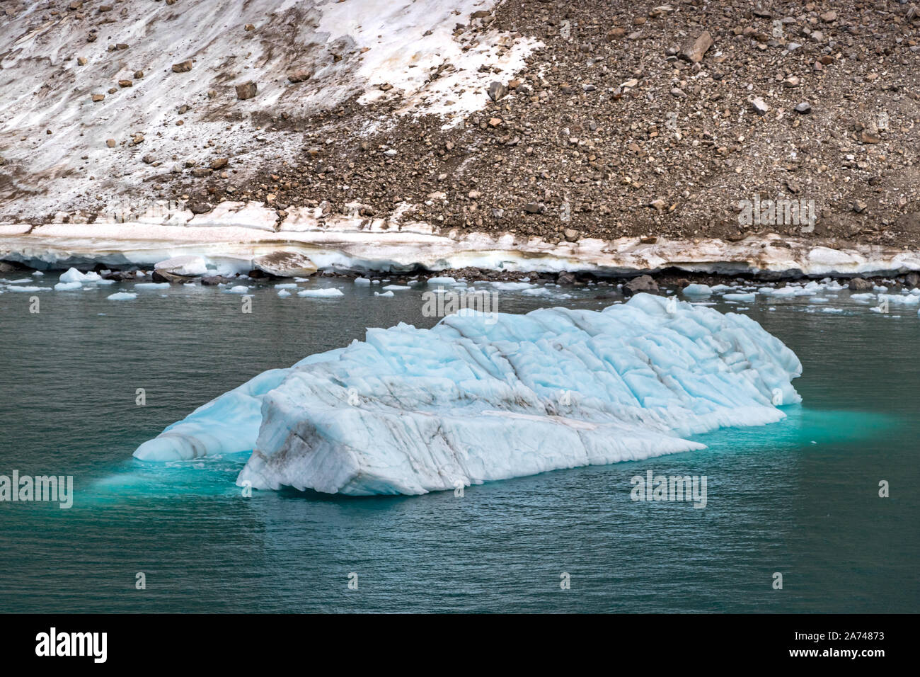 Iceberg next to the edge of a glacier in Ellesmere Island, part of the Qikiqtaaluk Region in the Canadian territory of Nunavut Stock Photo