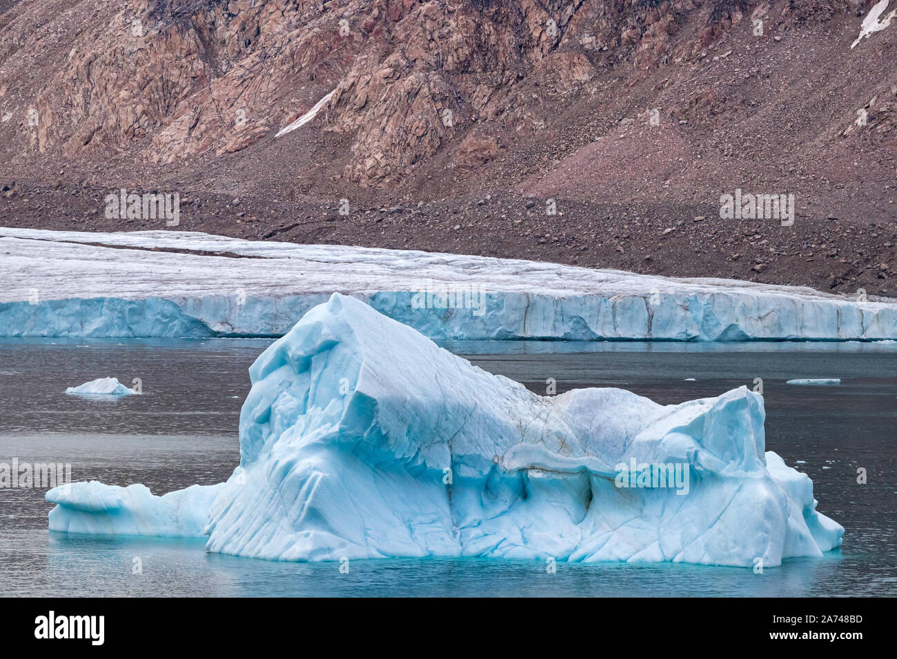 Iceberg next to the edge of a glacier in Ellesmere Island, part of the Qikiqtaaluk Region in the Canadian territory of Nunavut. Stock Photo