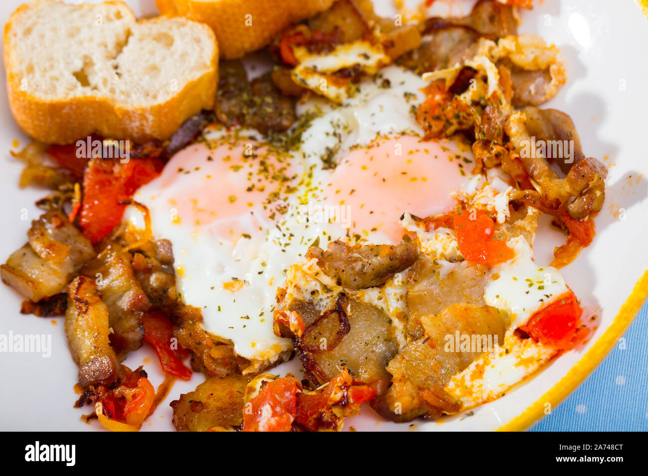 Roasted brisket with Scrambled eggs and vegetables served on plate