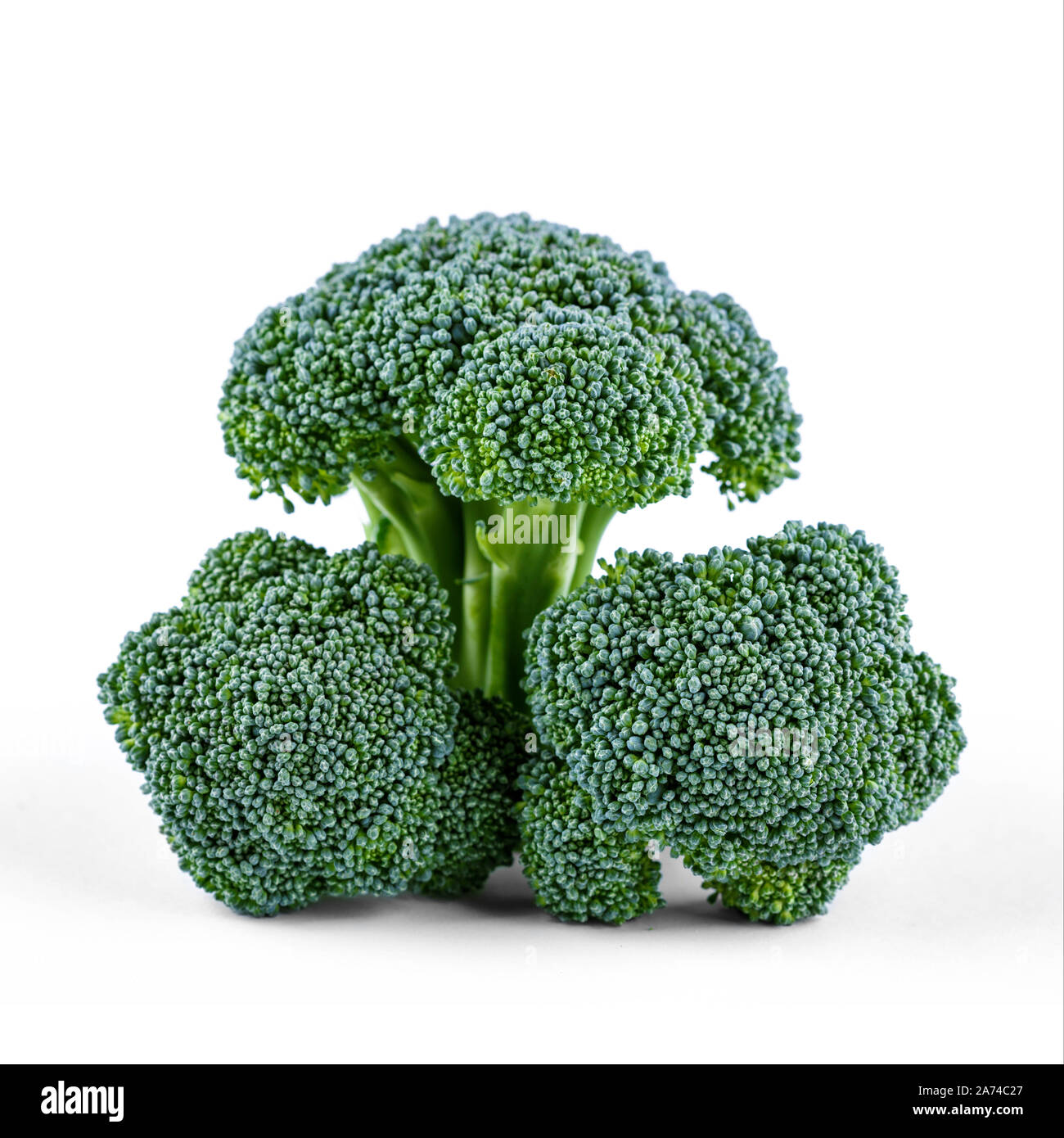 Three green broccoli isolated on white background Stock Photo - Alamy