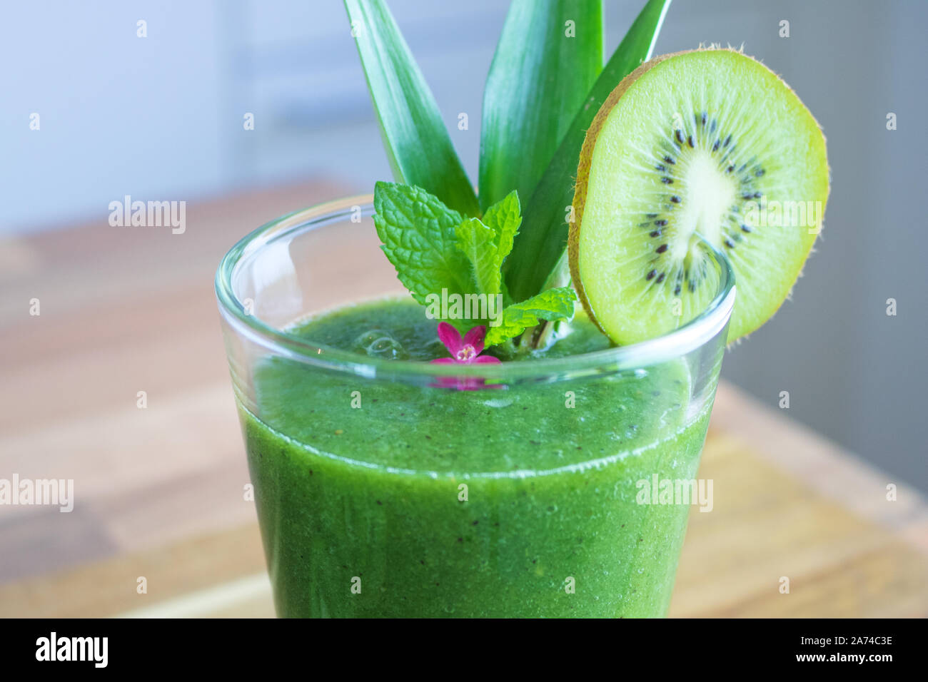 Food photography of a healthy green juice with chlorella and fruits