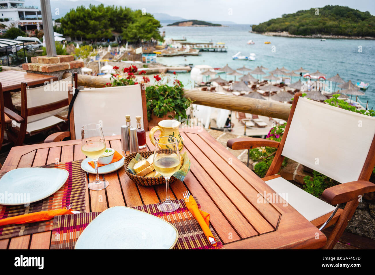 Restaurant with served table in seafront of Ionian sea on Ksamil Stock