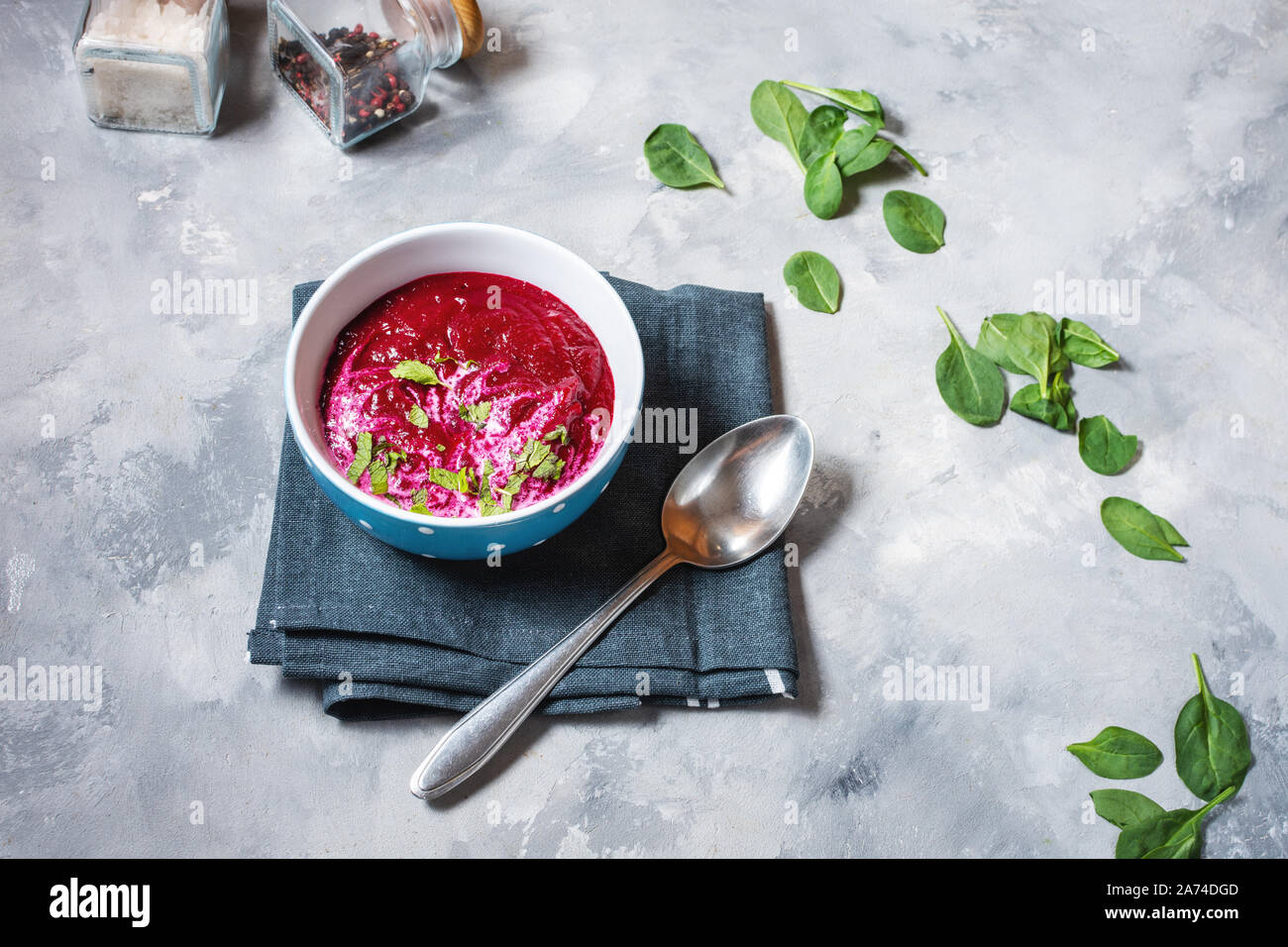 Soup of pureed red beets on concrete background Stock Photo