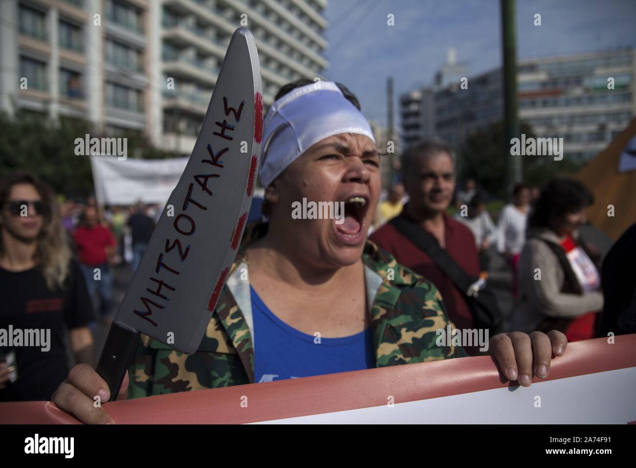 Employees public cleaning protest against law by Government partial privatization public service. Writing knife 'Kyriakos Mitsotakis'. 17.10.2019 | usage worldwide Stock Photo