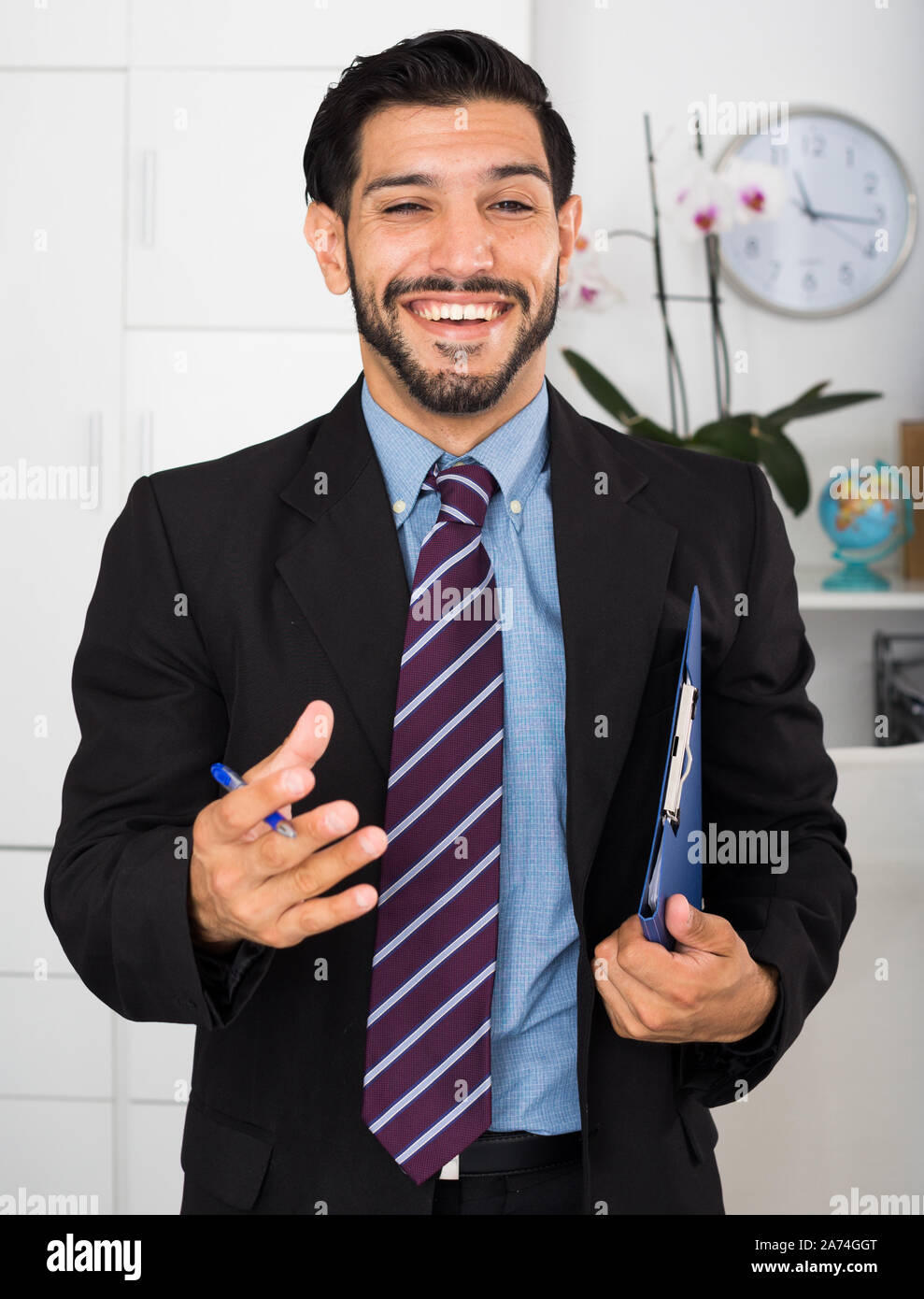 Spanish businessman is talking with partner about contract in office. Stock Photo