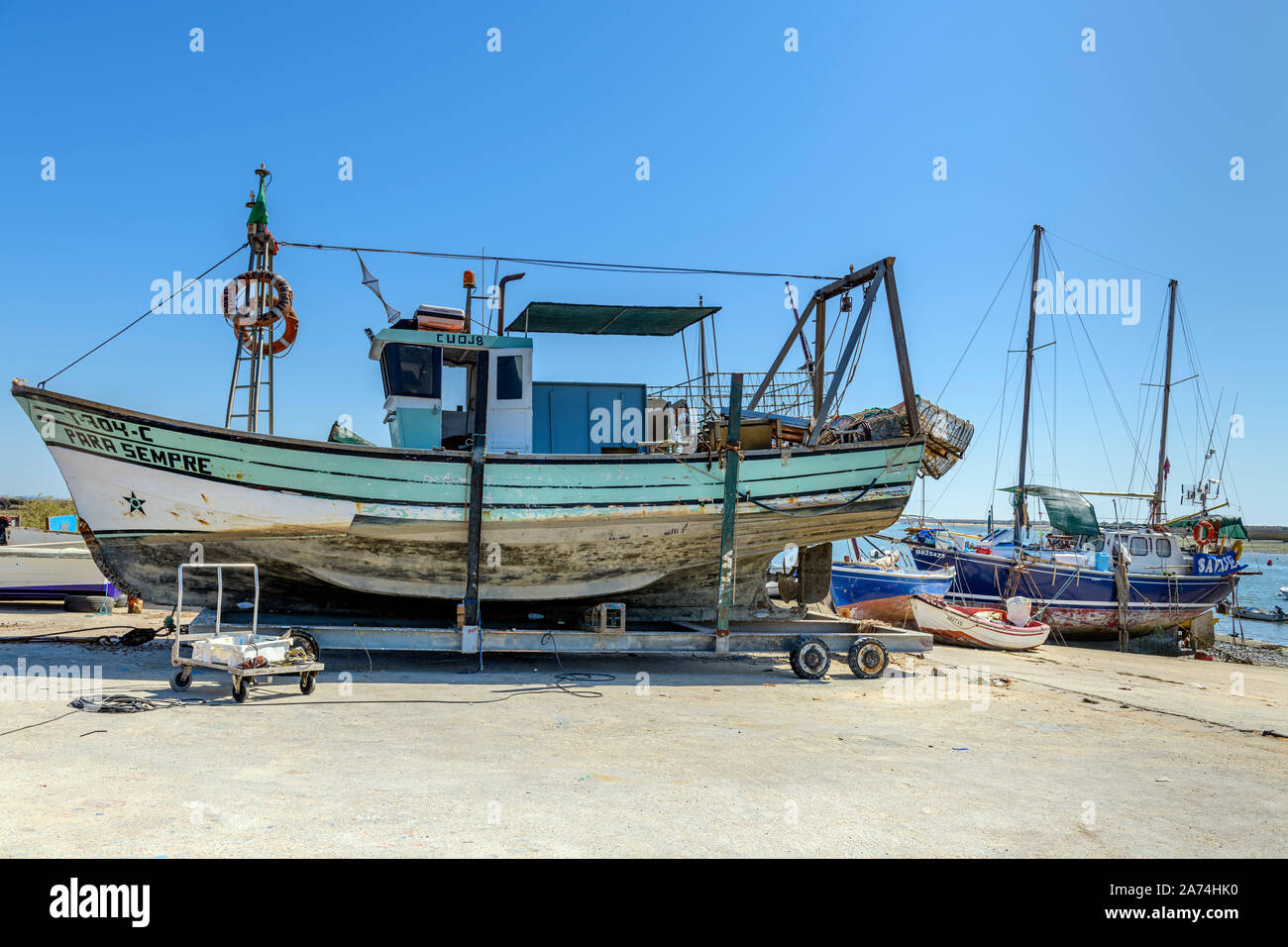 Santa Luzia fishing boat out of water dry dock under repair repairs, Santa Luzia, East Algarve, Portugal. Stock Photo