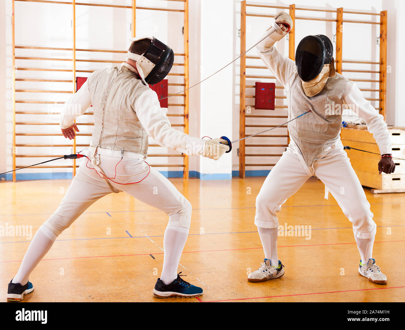active fencers at fencing workout, practicing attack movements in
