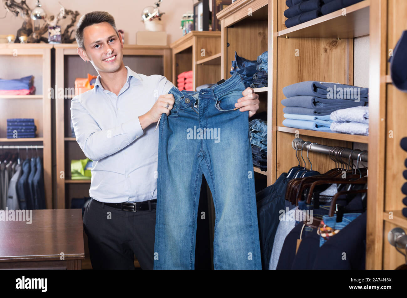 Male is choosing on new jeans in men's clothes store Stock Photo Alamy