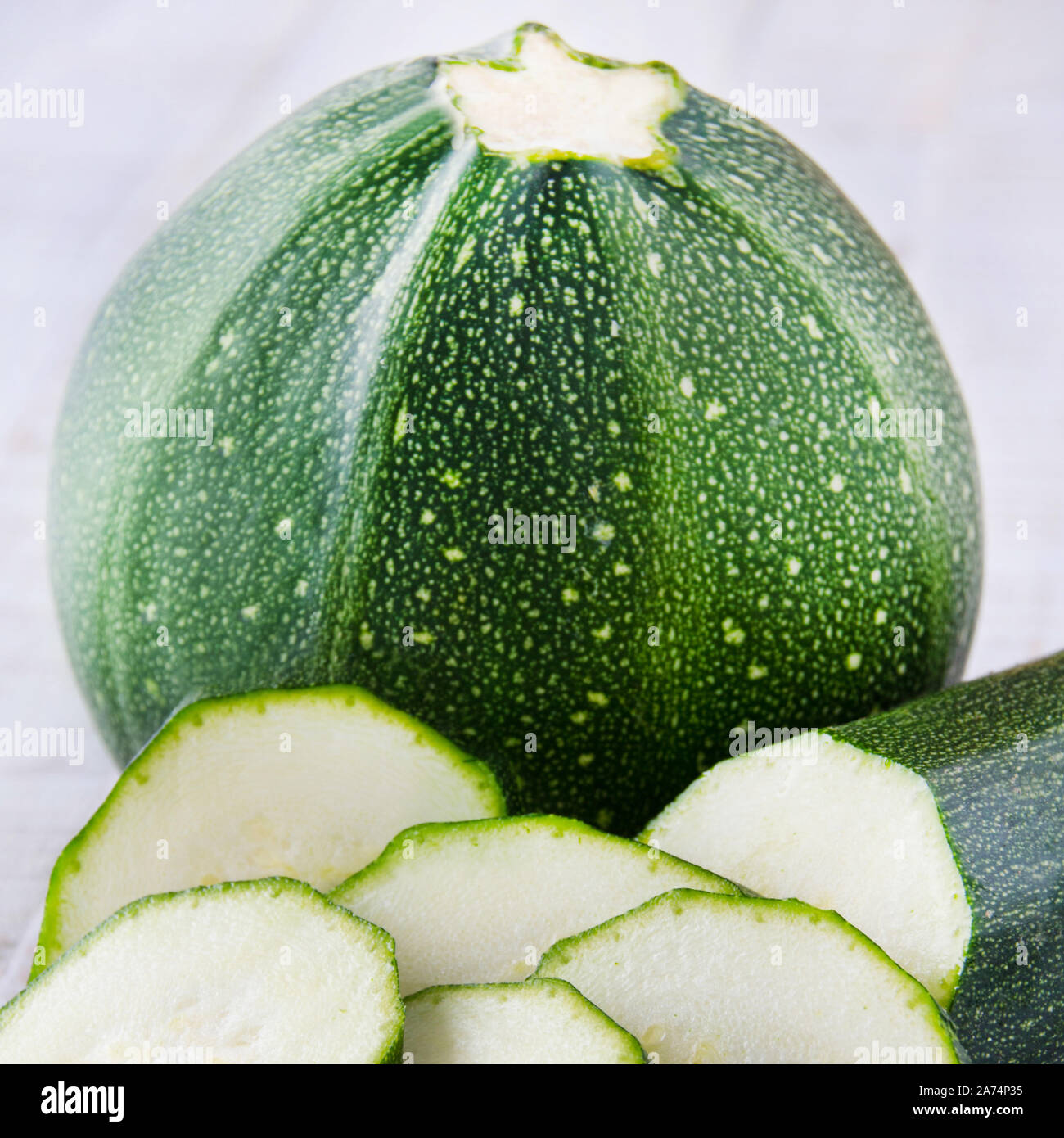 Chopped zucchini on white background Stock Photo Alamy